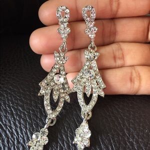 Long dazzling Earrings with white stones.